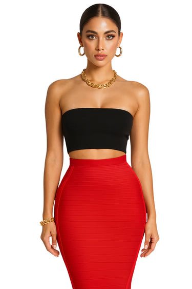 Woman wearing a black strapless top and red pencil skirt on a white background